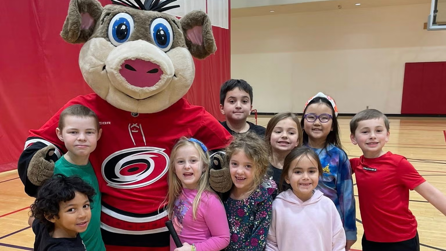 Kids at the Taylor Family YMCA with Carolina Hurricanes mascot Stormy