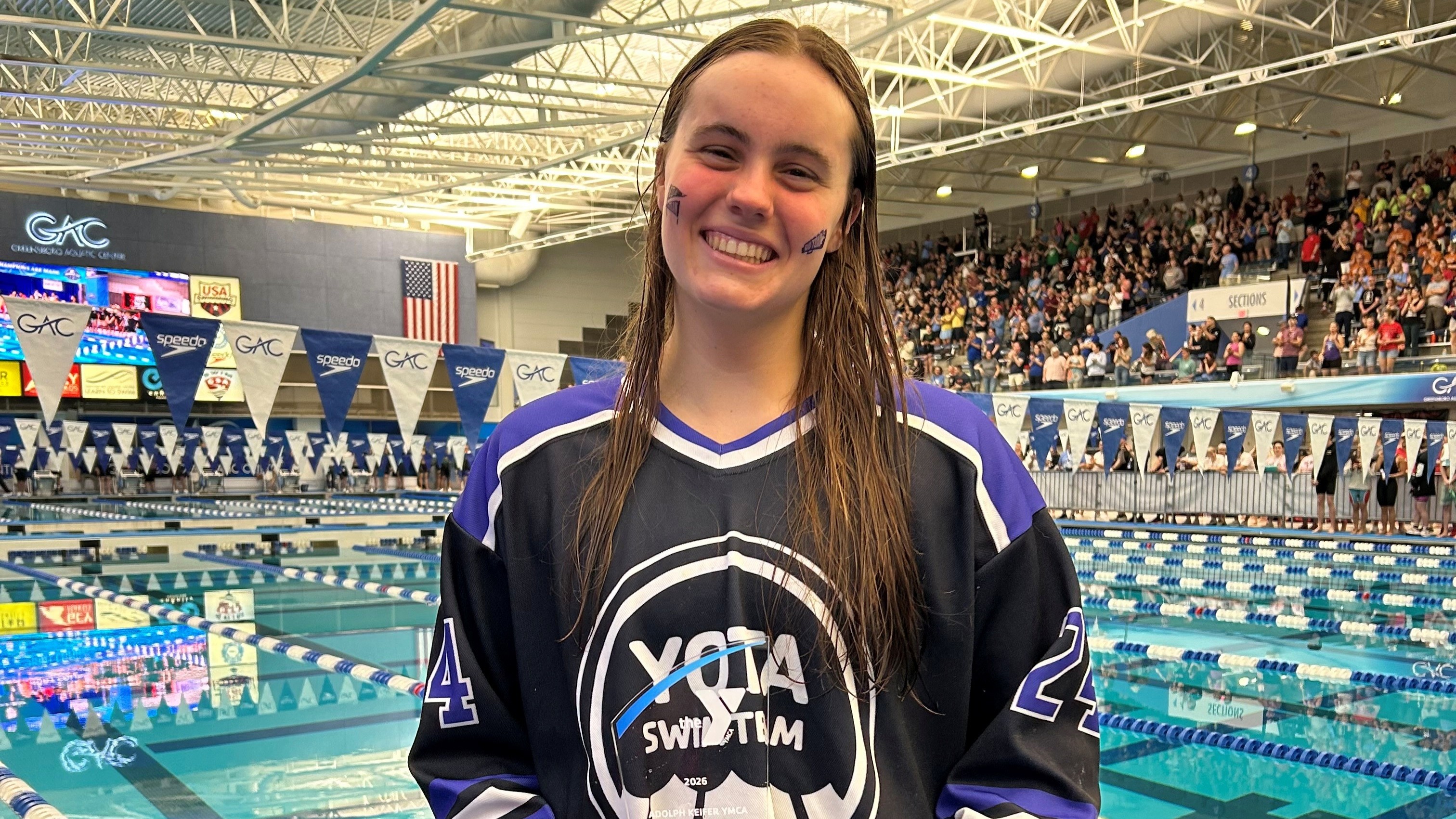 Aubrey Mitchell holding the 2026 Adolph Kiefer YMCA Youth Character Award