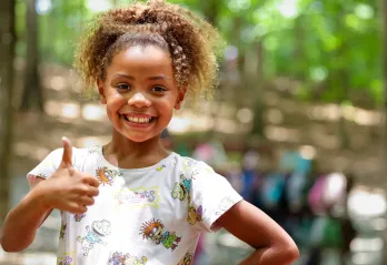 Girl giving a thumbs up