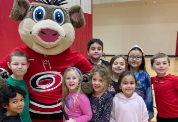 Kids at the Taylor Family YMCA with Carolina Hurricanes mascot Stormy