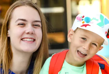 young boy with camp counselor