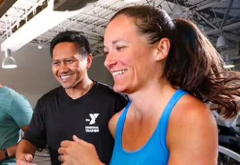 woman running on treadmill with coach