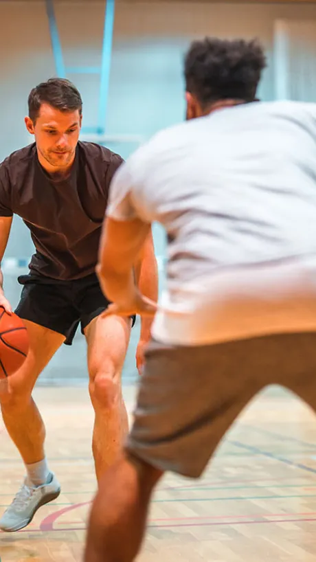 Two men playing pickup basketball