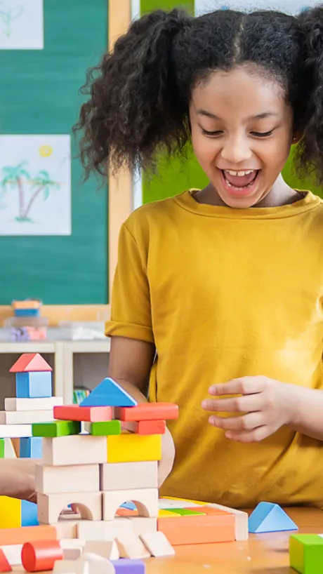 Three kids building a city with blocks