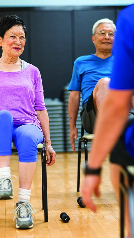 Two adults in chair fitness class