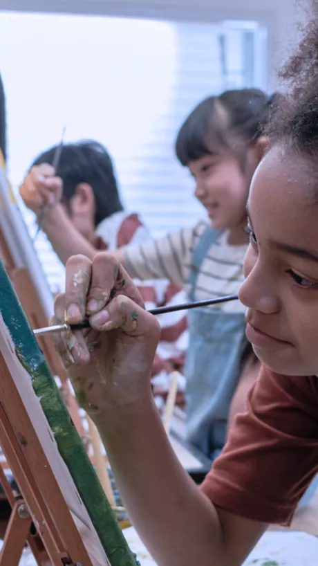 Girl painting at an easel