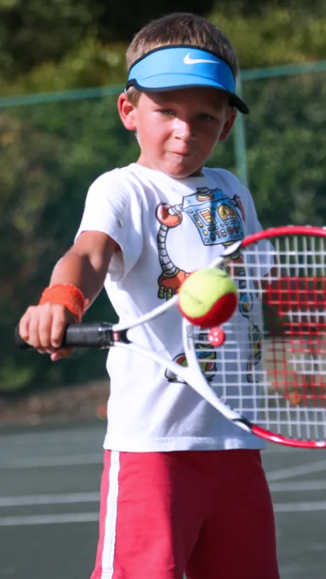 Boy practicing tennis