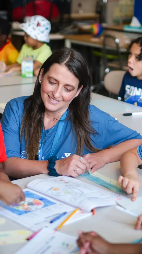 Children work on their reading and math skills with their teacher at YMCA Power Scholars