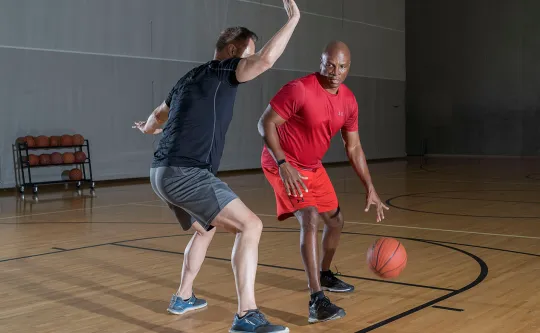 Men playing pickup basketball at the Y