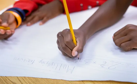 child working on multiplication problems