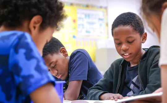 group of kids practicing reading skills