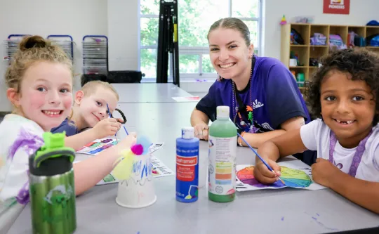Kids working on a craft at YMCA day camp.