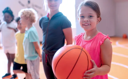 Young kids leaning basketball skills