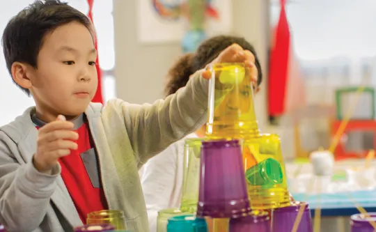 Boy stacking cups