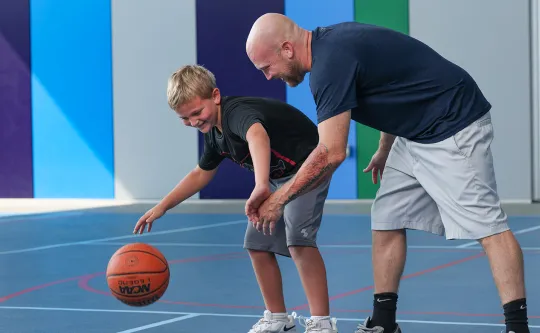 Father and son playing basketball