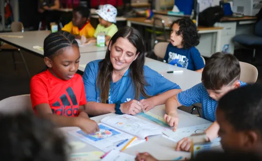 Children work on their reading and math skills with their teacher at YMCA Power Scholars