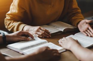 women reading the bible together