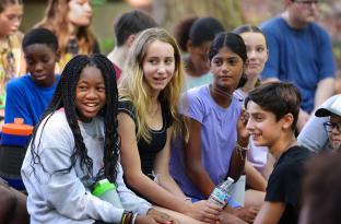 Group of teens sitting together outside