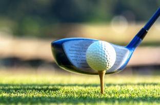 Golf club lined up with the ball