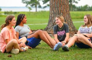 Group of teens sitting together at overnight camp