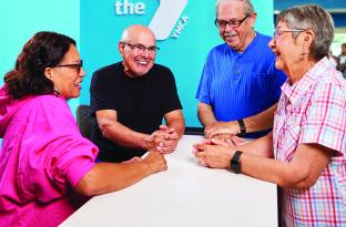 senior citizens gathering around a front desk socializing