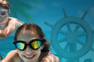 Family swimming with pirate gear around them underwater with goggles