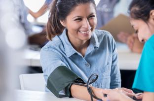 Woman getting blood pressured checked | YMCA Health Fair
