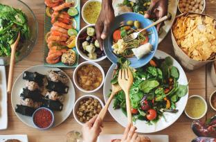 Table set with various kinds of international food dishes