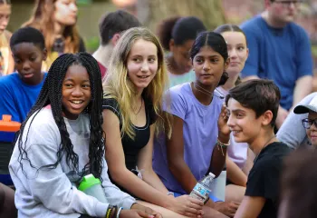 Group of teens sitting together outside