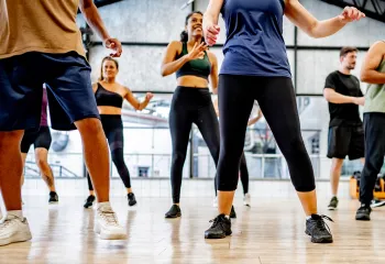 Group of people practicing line dancing