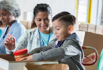 Mother and son volunteering at a food drive