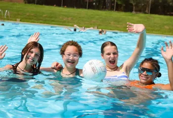 friends playing water volleyball