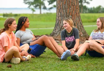 Group of teens sitting together at overnight camp