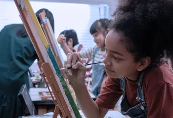 Girl painting at an easel