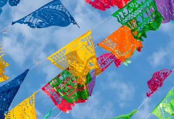 Mexican Celebration Flags against a blue sky