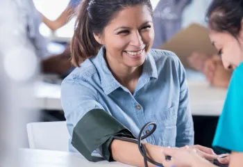 Woman getting blood pressured checked | YMCA Health Fair