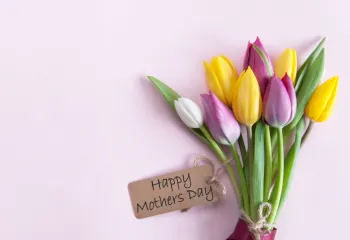 Flower laying on table with a happy mother's day note 