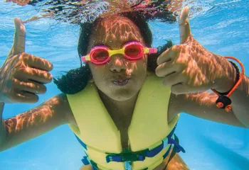 Swimmer underwater giving a thumbs-up