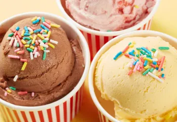 ice cream with sprinkles in round colorful cups