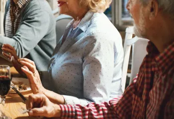 older adults at a sophisticated dinner table