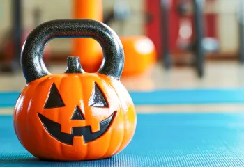 a kettlebell shaped like a pumpkin on the gym floor