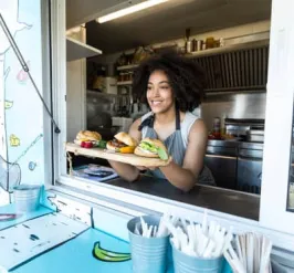 food truck vendor offering sandwiches