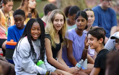 Group of teens sitting together outside