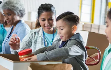 Mother and son volunteering at a food drive