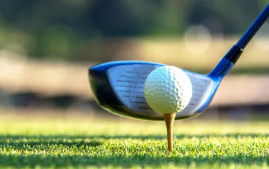 Golf club lined up with the ball