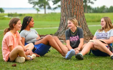 Group of teens sitting together at overnight camp