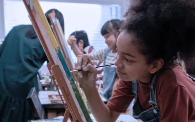 Girl painting at an easel