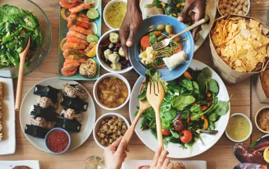 Table set with various kinds of international food dishes