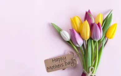 Flower laying on table with a happy mother's day note 
