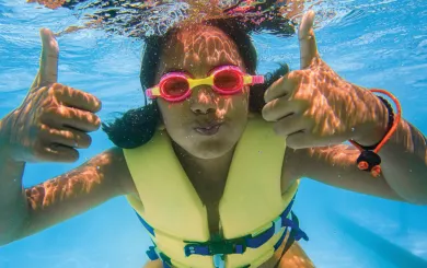 Swimmer underwater giving a thumbs-up
